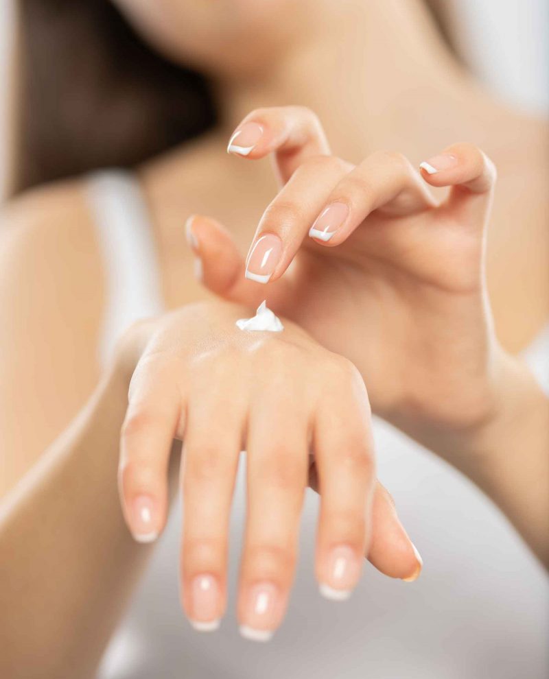 woman-applies-a-cosmetic-moisturizer-on-her-hands-QF4K8NX.jpg